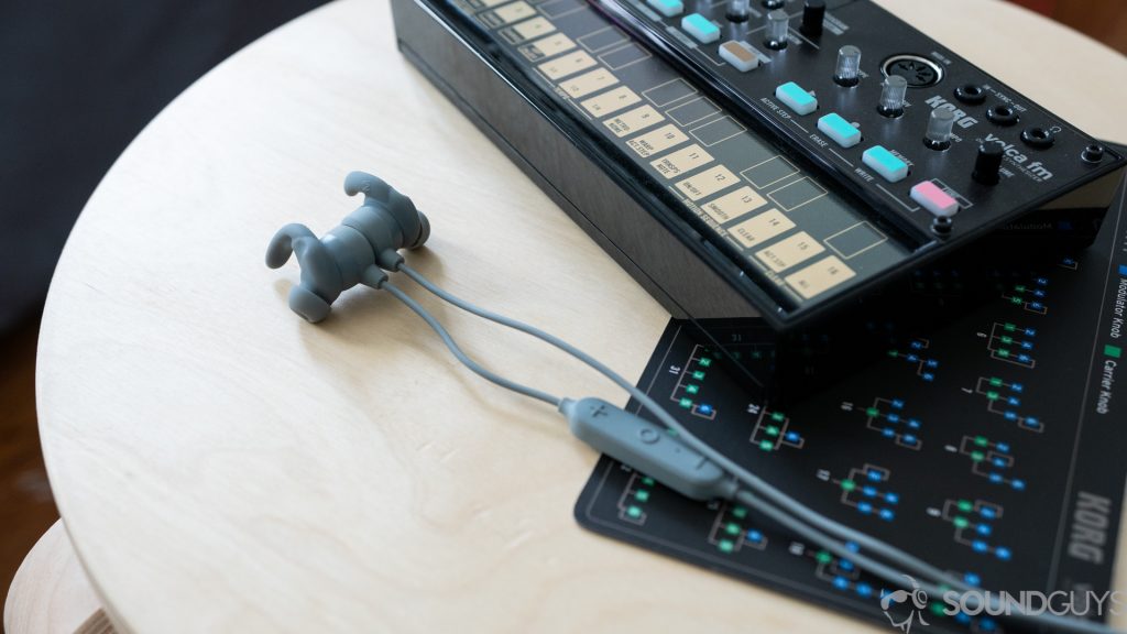 Pictured are the Aukey EP-B60 earbuds on a stool. 