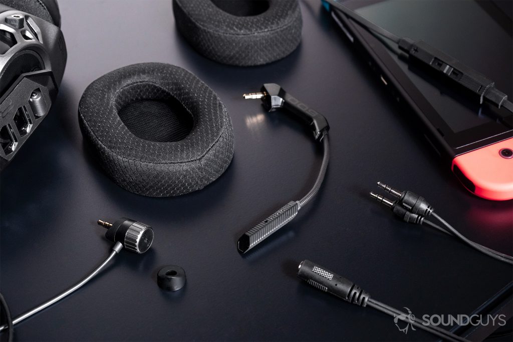 An angled image of all inclusions of the headset laid out on a black surface.