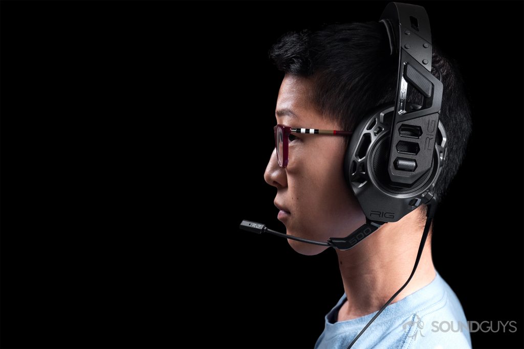 Gaming headset: The profile of a woman wearing the headphones with the boom mic close to the lens.