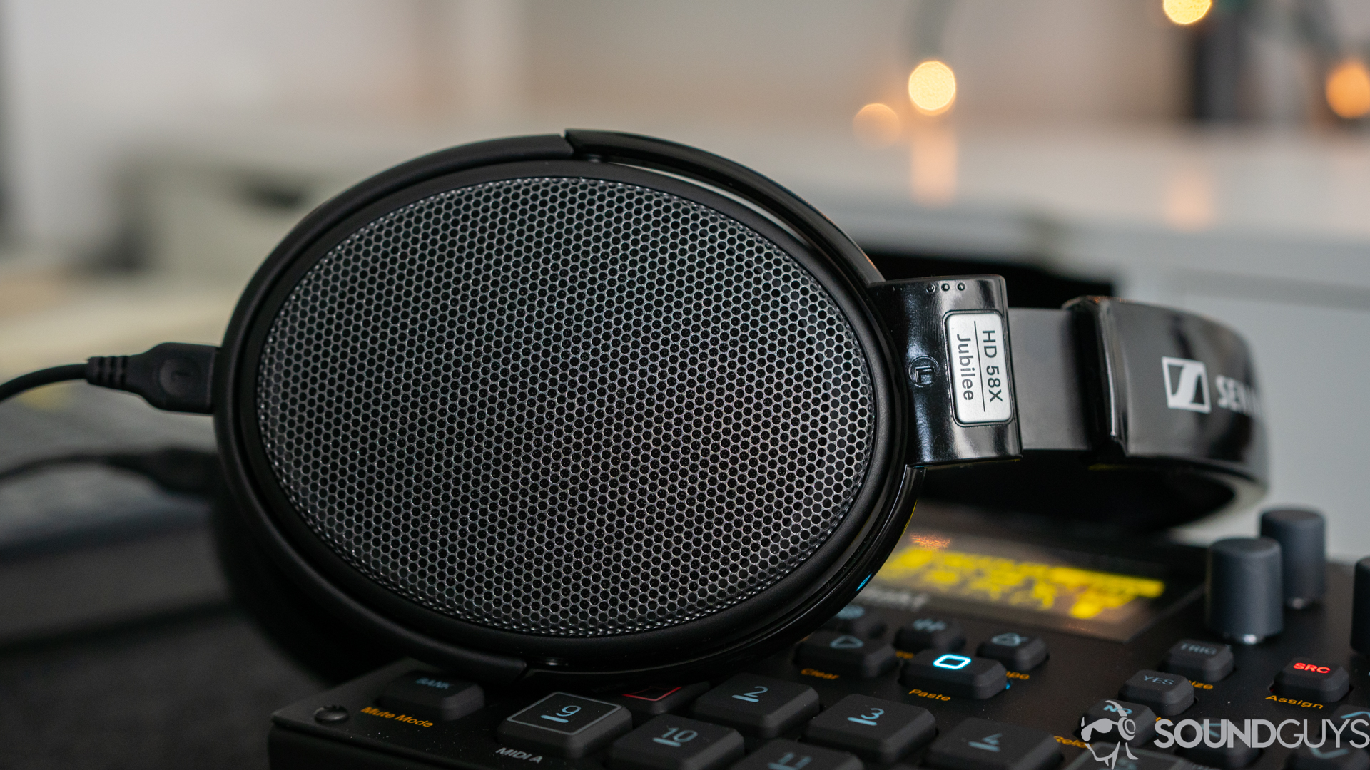 Pictured is the Sennheiser HD 58X laying on a desk.