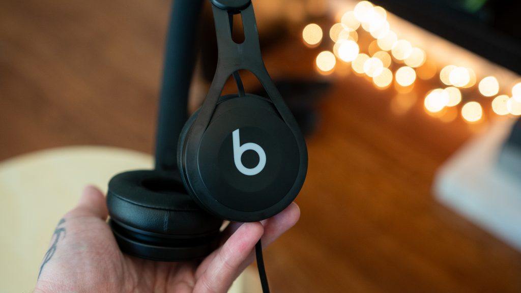 Adam holding the Beats EP headphones in hand.