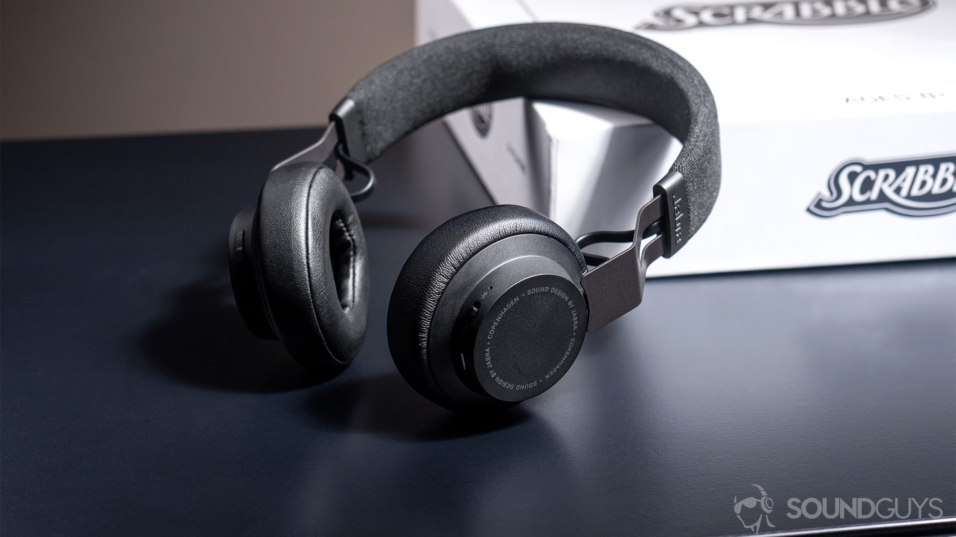 Jabra Move Wireless: The headphones propped up against a white Scrabble box.