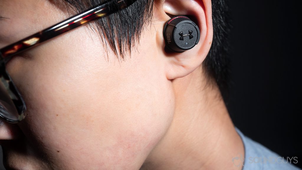 A picture of the Under Armour True Wireless Flash JBL worn by a woman.