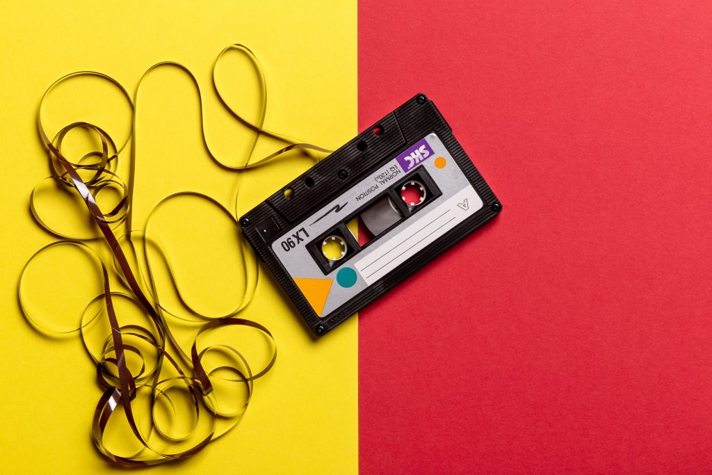 Vinyl: A photo of a cassette with its magnetic tape de-spooled.