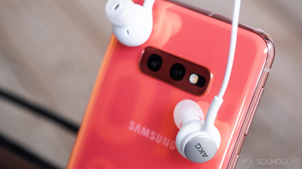 The AKG Samsung Galaxy S10e earbuds leaning against the rear of the phone.