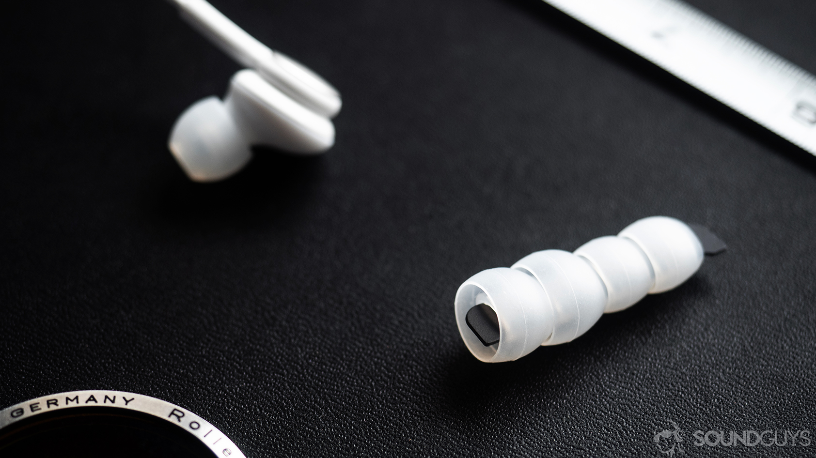 The AKG Samsung Galaxy S10e earbuds spare era tips on a black surface.
