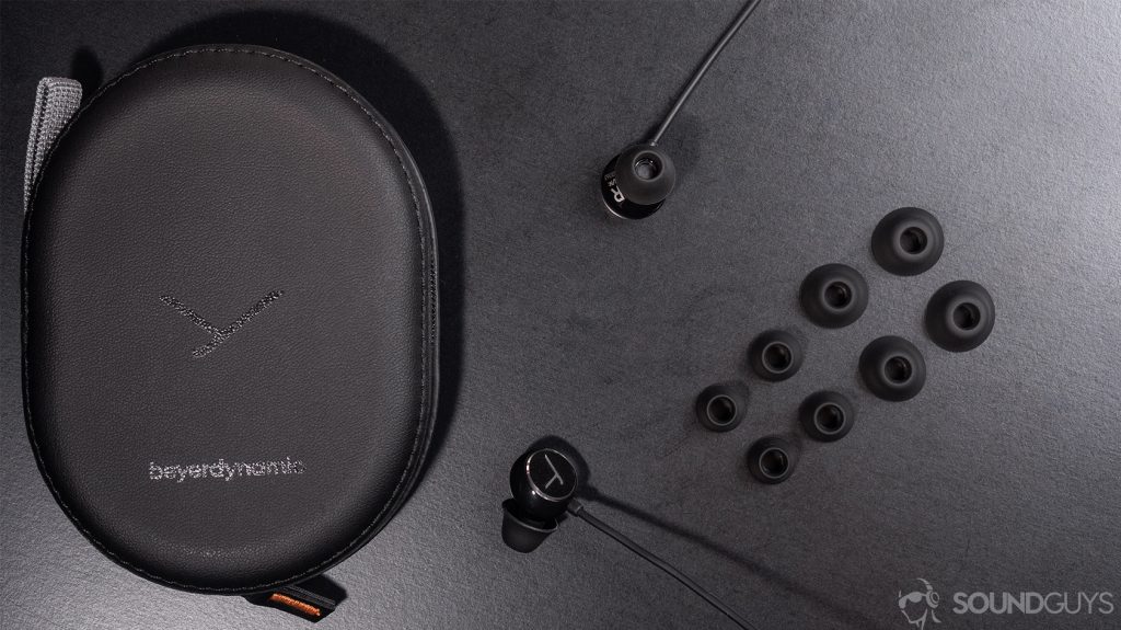 Beyerdynamic Blue Byrd: the case, spare ear tips, and earbuds on a black table.
