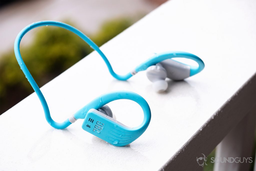 JBL Endurance Dive: The headphones on a balcony railing with rain on them.