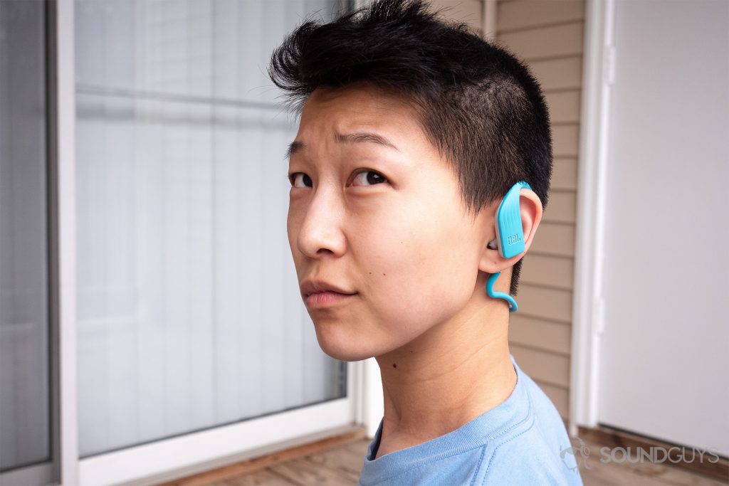 Best on-ear headphones JBL Endurance Dive: A woman wearing the headphones to display the sizing.