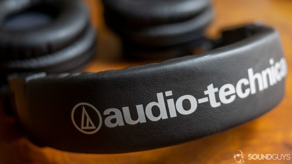 The Audio-Technica ATH-M50xBT on a wooden desk.