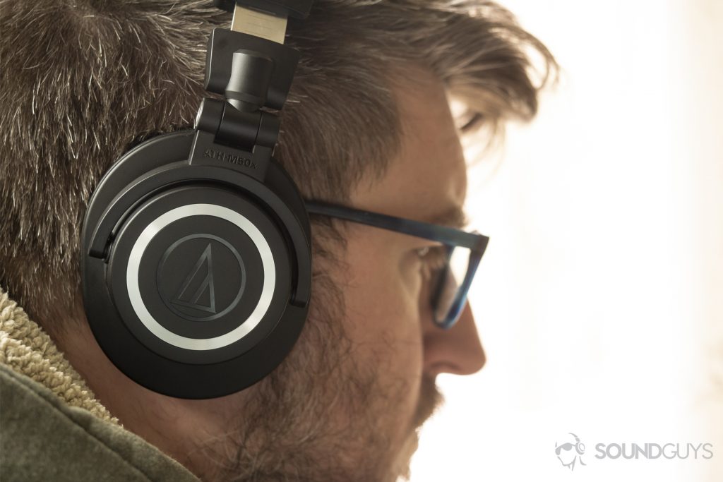 A photo of the Audio-Technica ATH-M50xBT on a man's head - Best over-ear headphones under $100