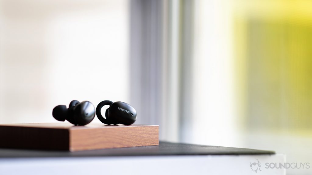 A photo of the 1More Stylish true wireless resting on a wood block.
