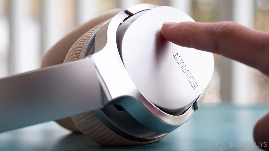 best wireless headphones Edifier W860NB: A hand on the touch panel of the headphones.