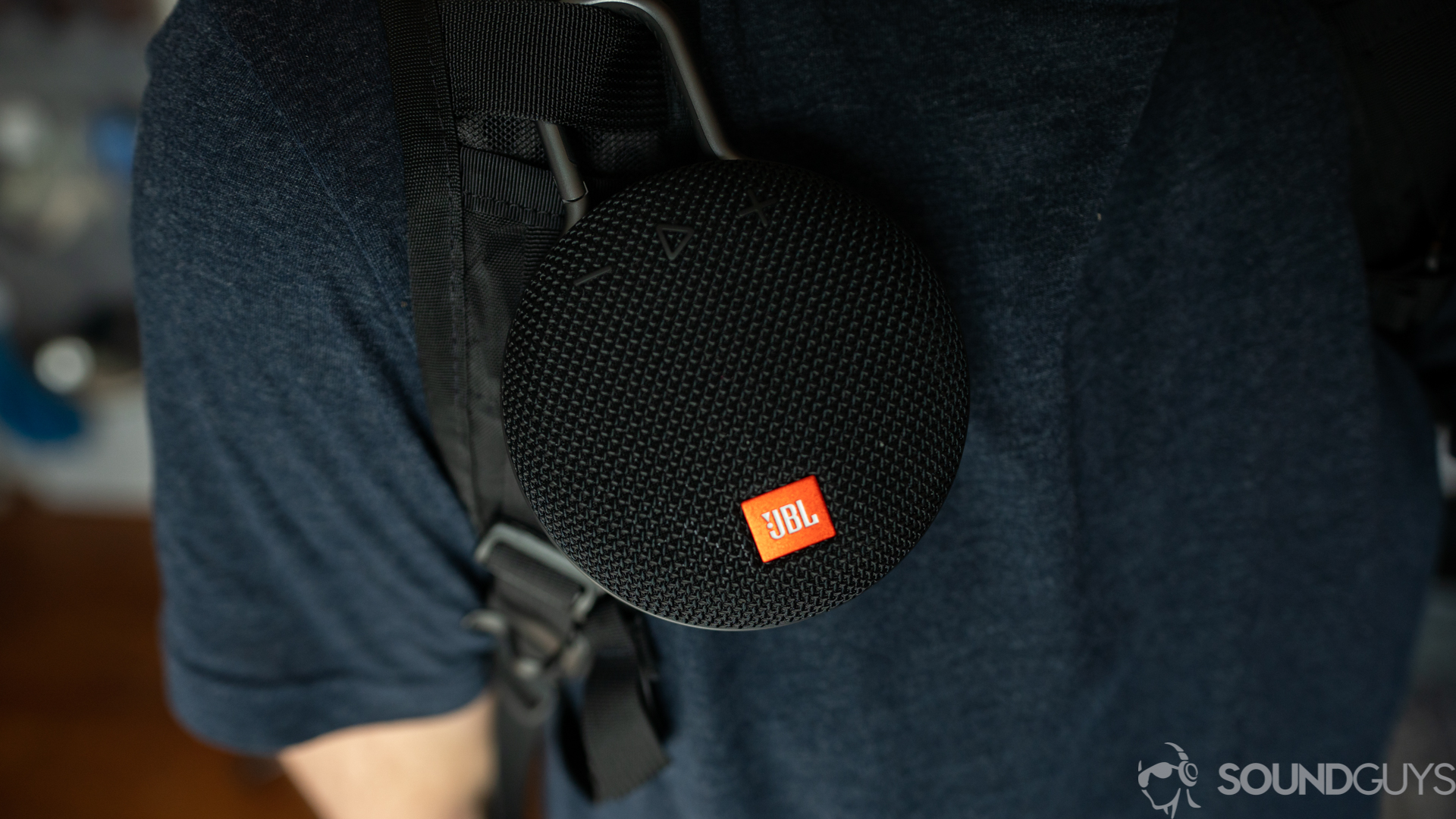 Pictured is the JBL Clip 3 attached to a backpack strap.