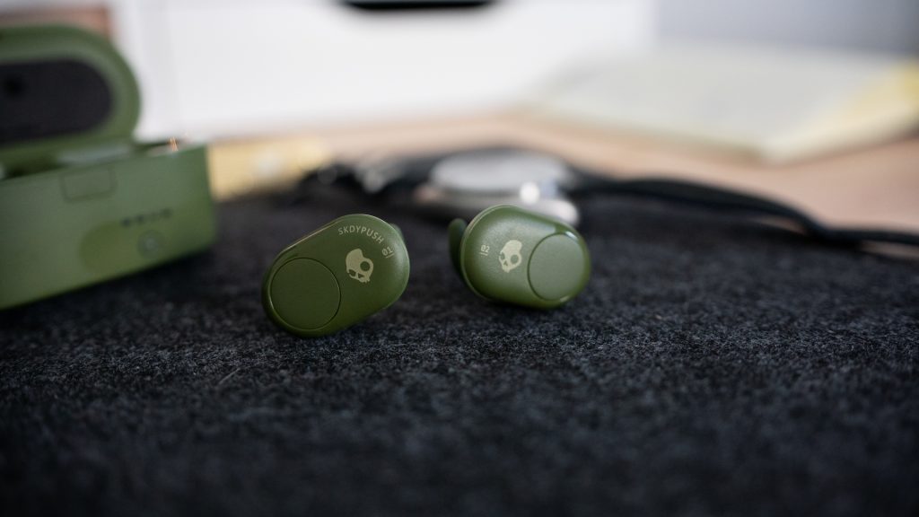 The Skullcandy Push true wireless earbuds on a felt desk mat. 
