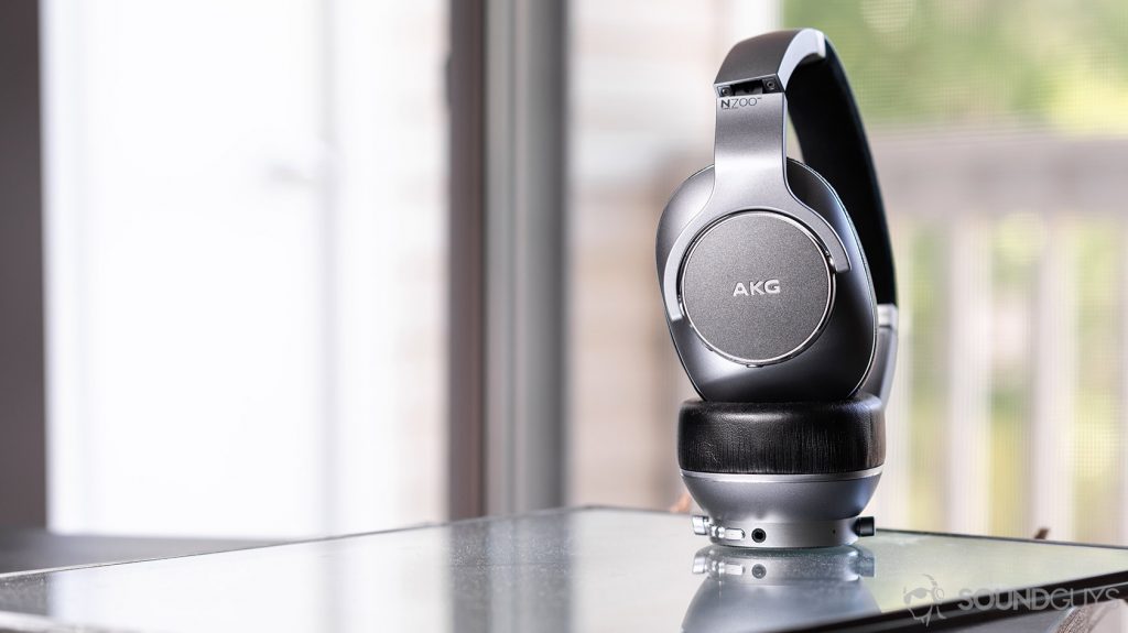 AKG N700NC: Headphones standing vertically against a window.