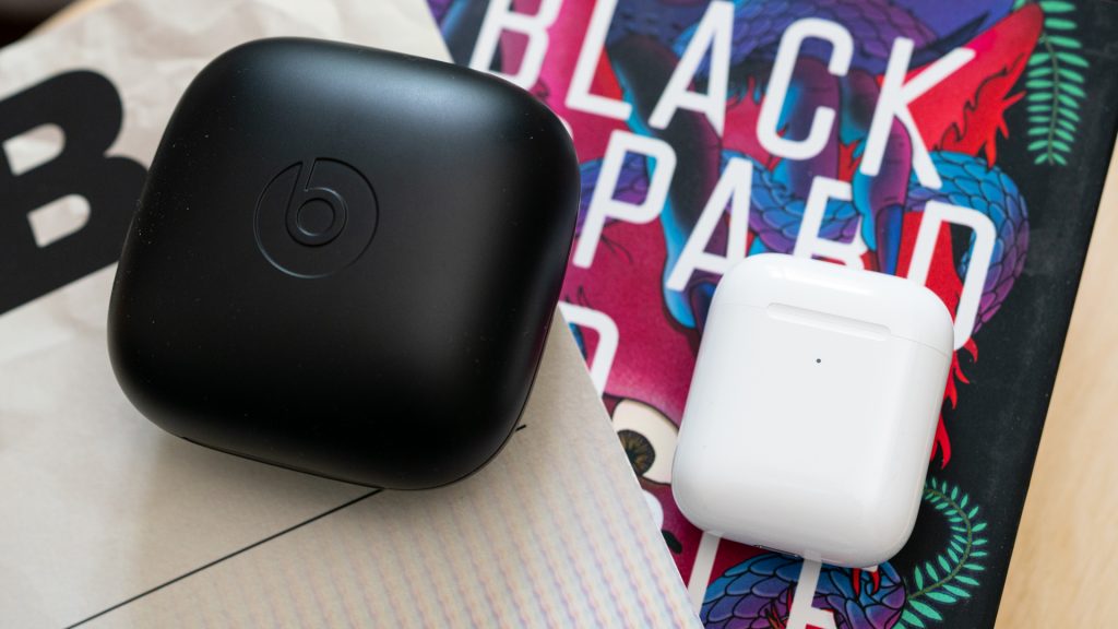 Powerbeats Pro and Apple Airpods charging case side by side. 