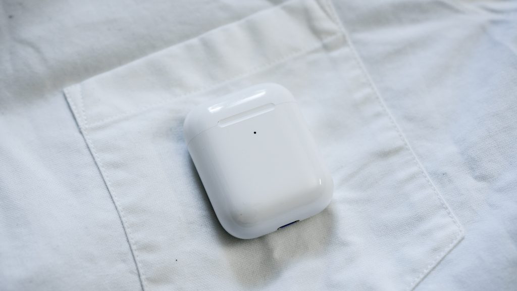 Shot of the Apple Airpods charging case on a white dress shirt.
