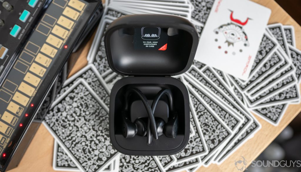 The Beats Powerbeats Pro resting in their charging case on a desk.