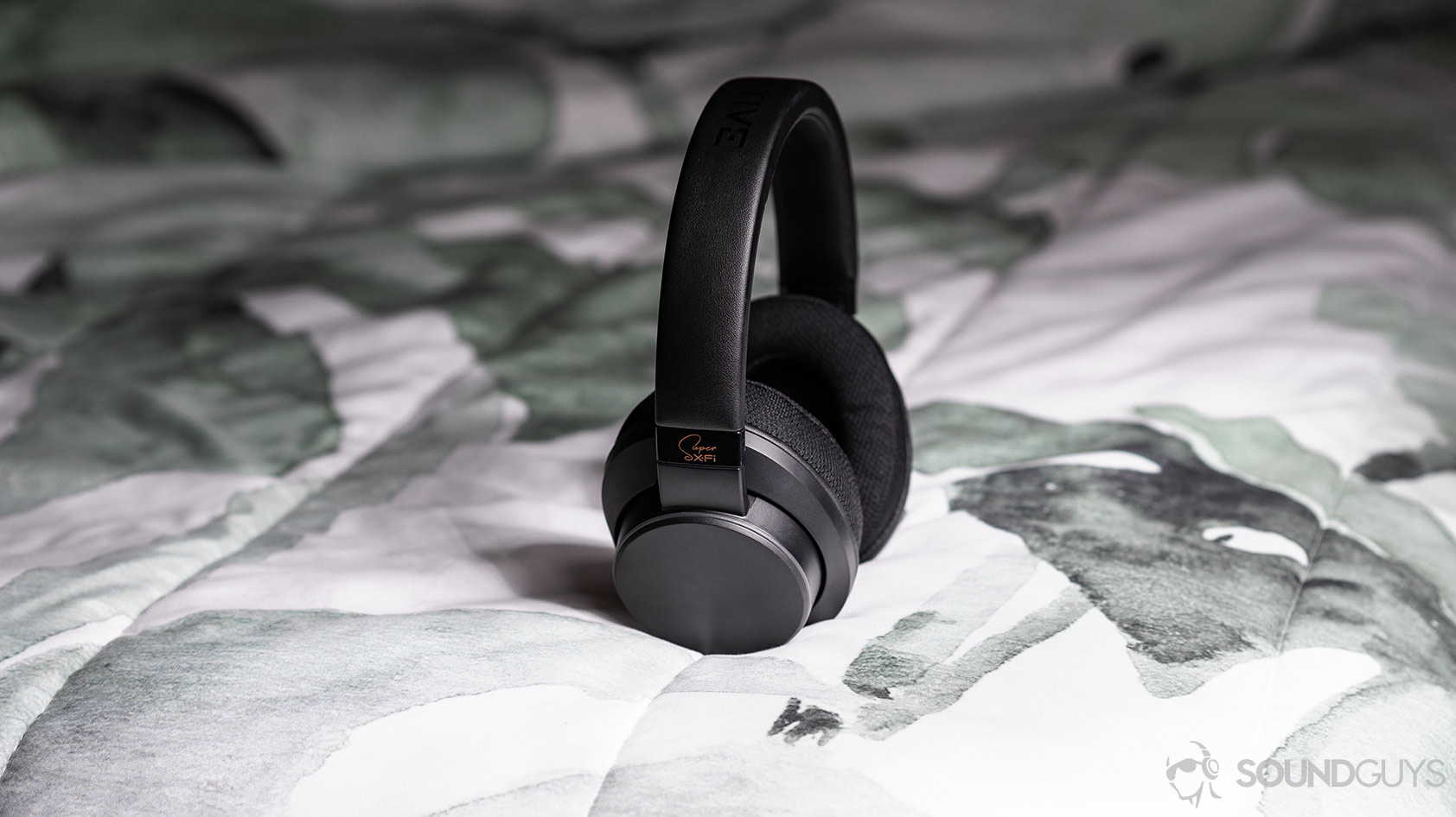 Creative SXFI Air: The headphones standing up on a bed.