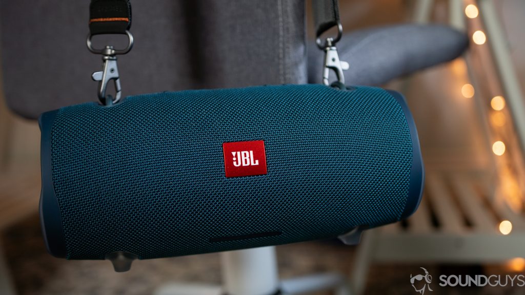 Shot of the JBL Xtreme 2 hanging from a gray chair thanks to the strap.