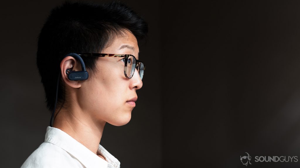 A picture of a woman wearing the Jabra Elite Active 45e running earbuds.