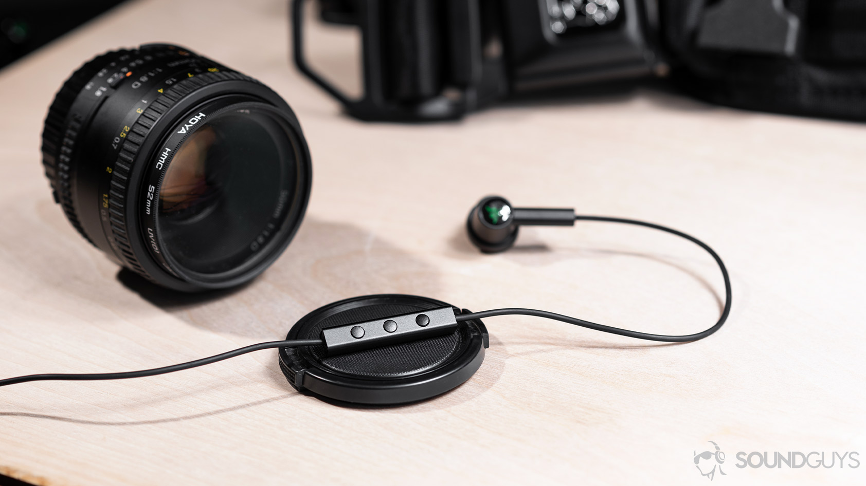 The Hammerhead Duo mic remote on a lens cap with a Nikon lens in the background.