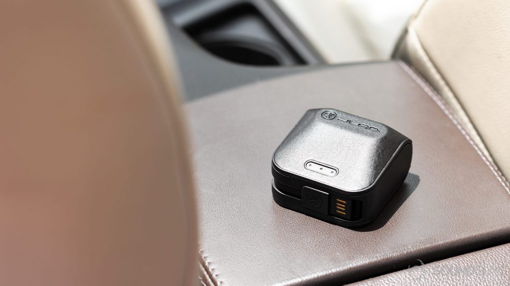 The charging case, closed and with LED indicators lit.