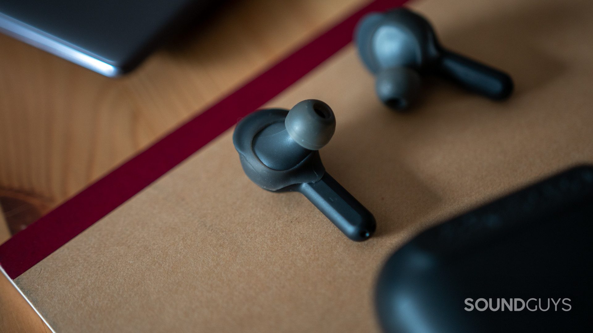 The Skullcandy Indy true wireless earbuds on a notebook.