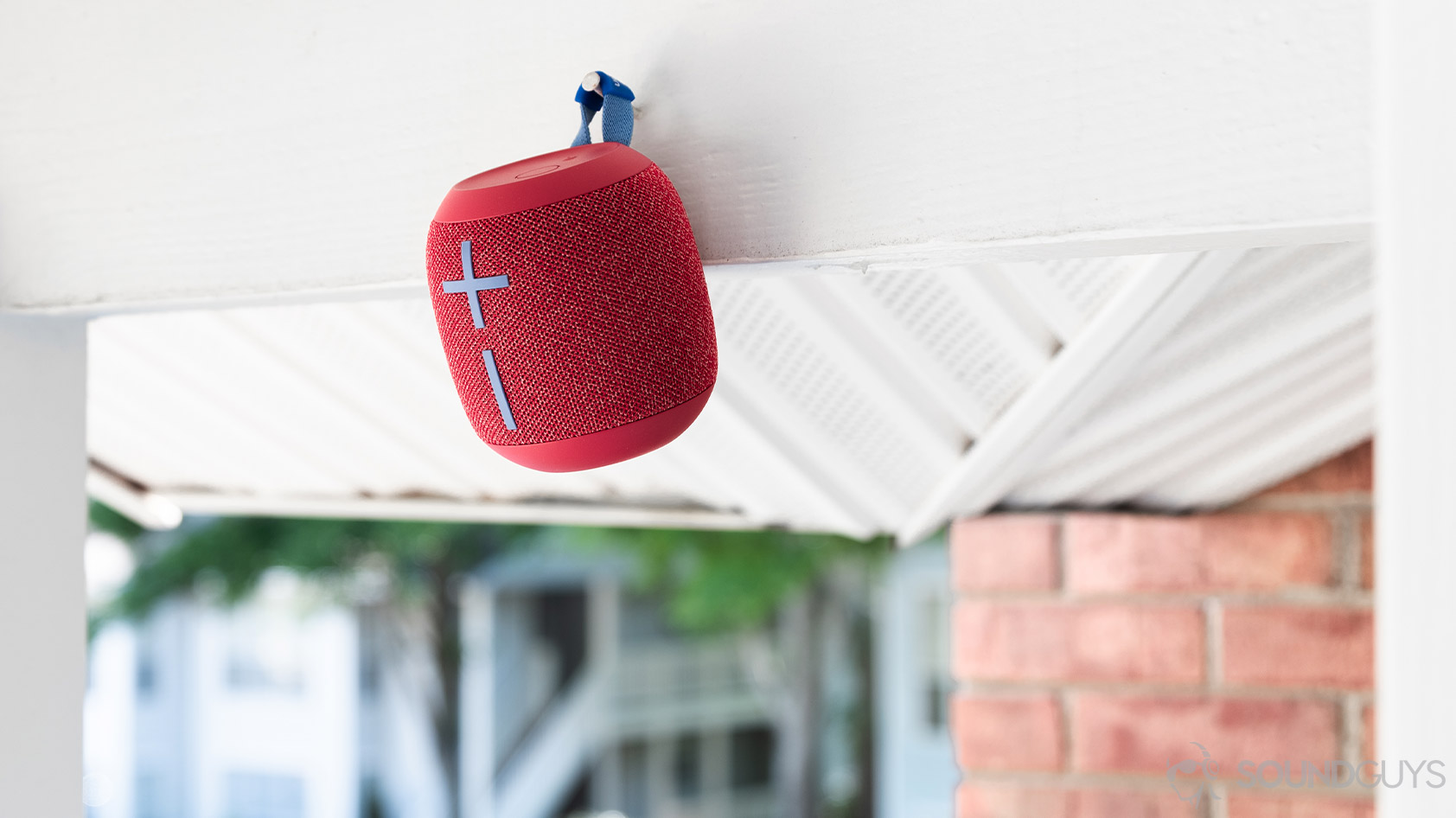 The UE Wonderboom 2 hanging from a nail on a balcony.