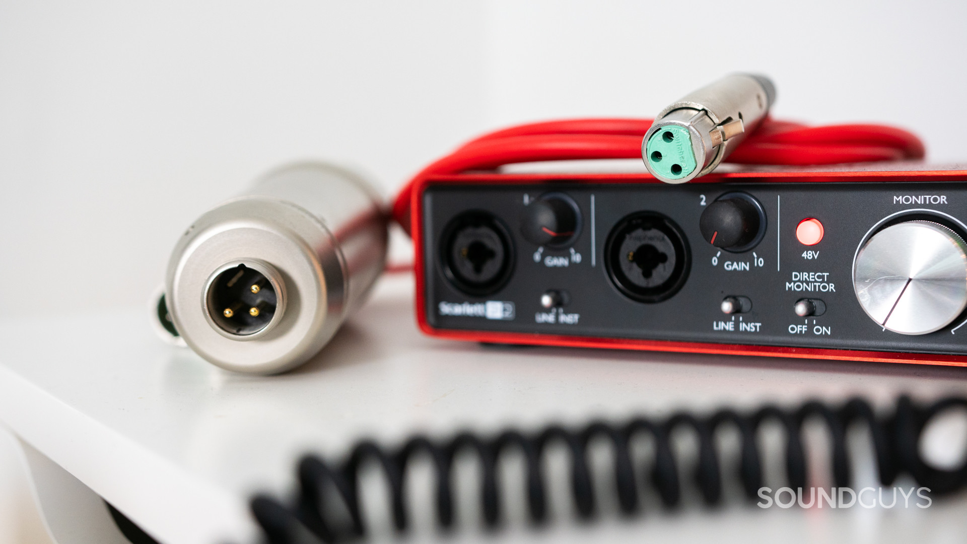 Close-up shot of the pins in an XLR cable and on a microphone and audio interface