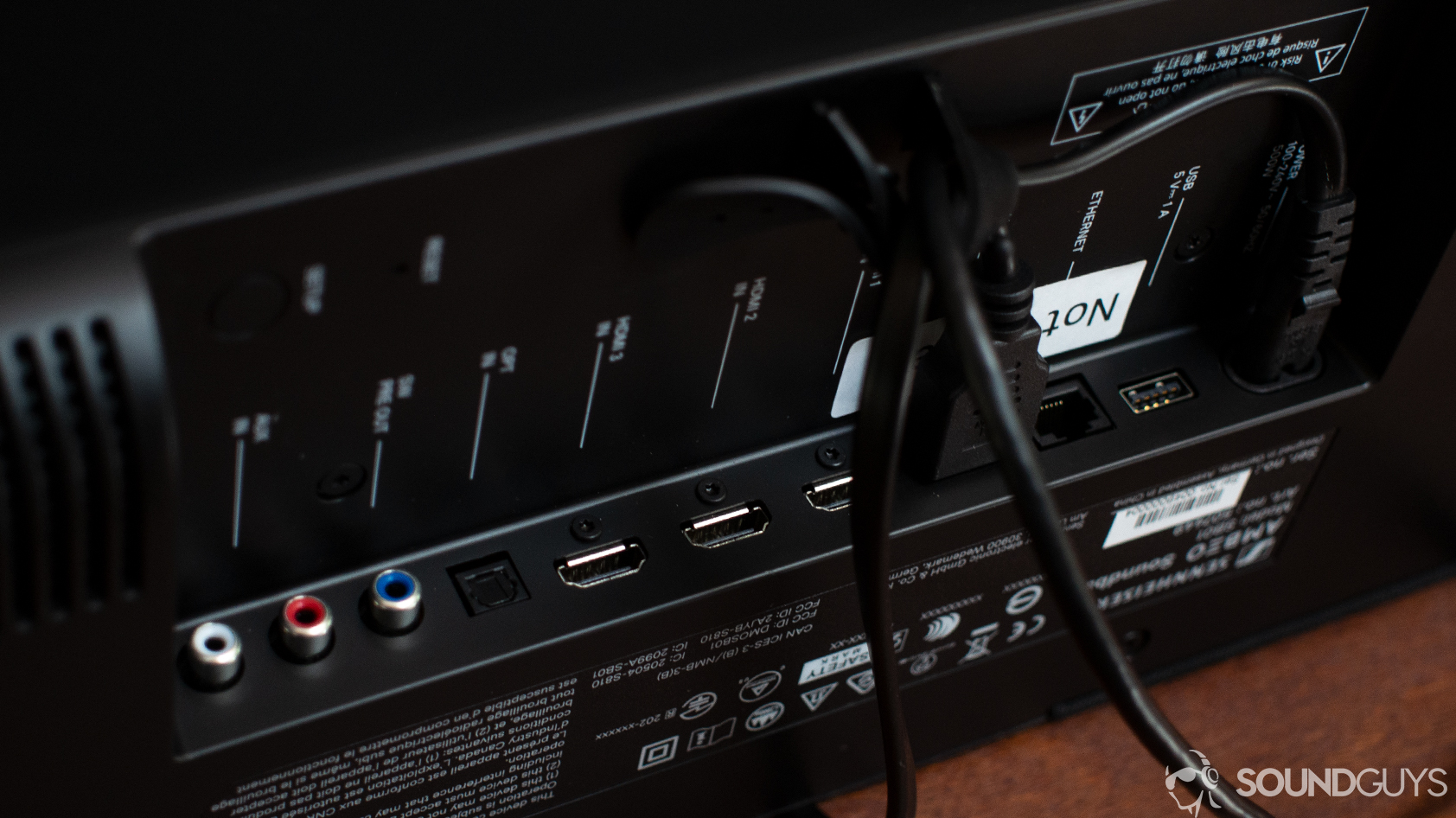 A photo of the ports and cable management system of the Sennheiser Ambeo Soundbar.