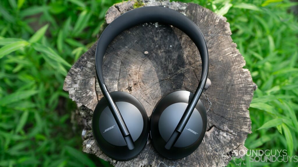 An aerial image of the Bose Noise Cancelling Headphones 700 outside on a tree stump.