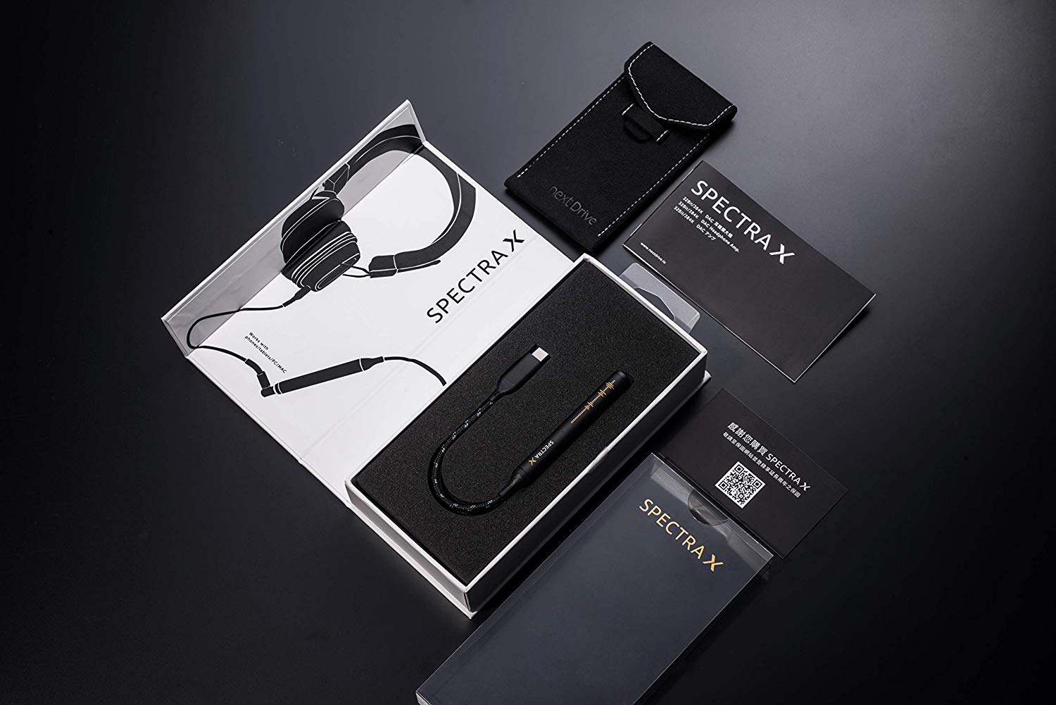 NextDrive Spectra X in packaging with the case laid out on a black table.