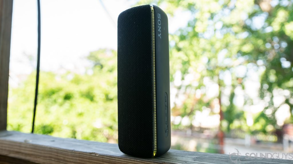 The Sony SRS-XB32 speaker positioned vertically on a banister.