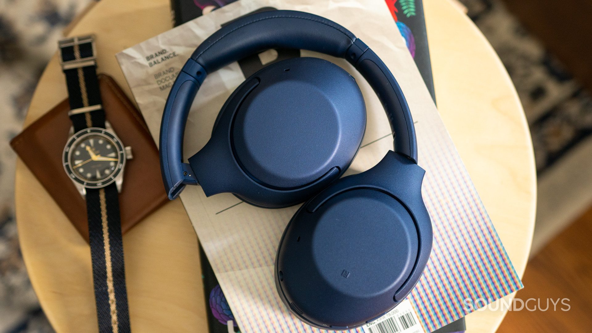 The Sony WH-XB900N headphones on a small table.