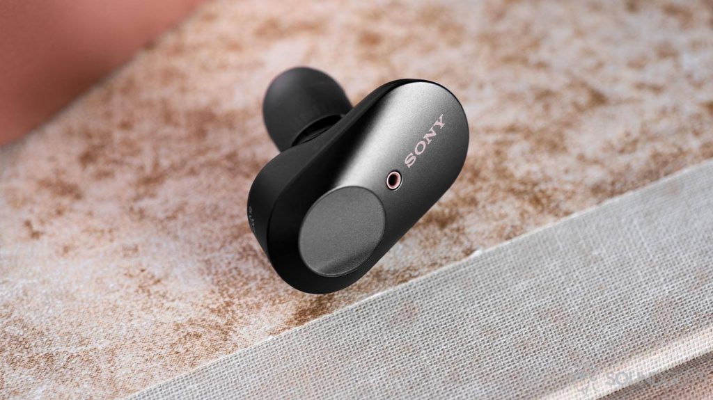 Close-up image of a Sony WF-1000XM3 earbud with the touch panel clearly visible.