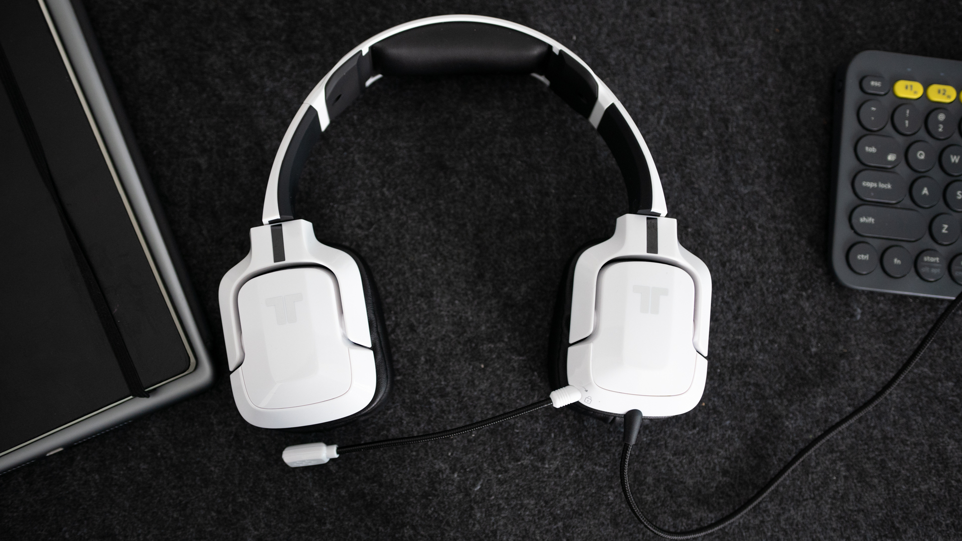 Pictured is the Tritton Kunai Pro from the top while it's next to a keyboard.