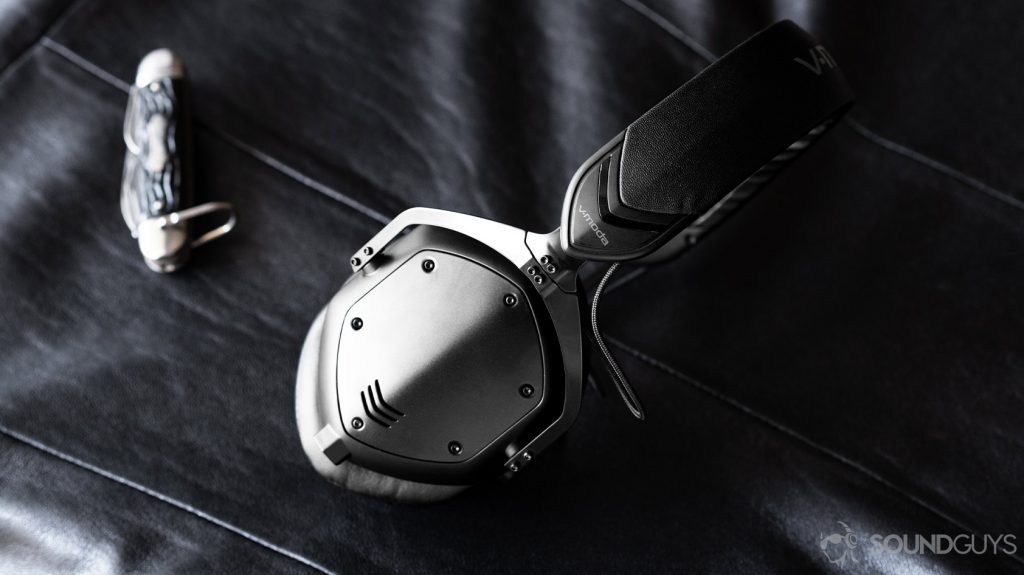 The V-Moda M-100 Master headphones on a leather surface.