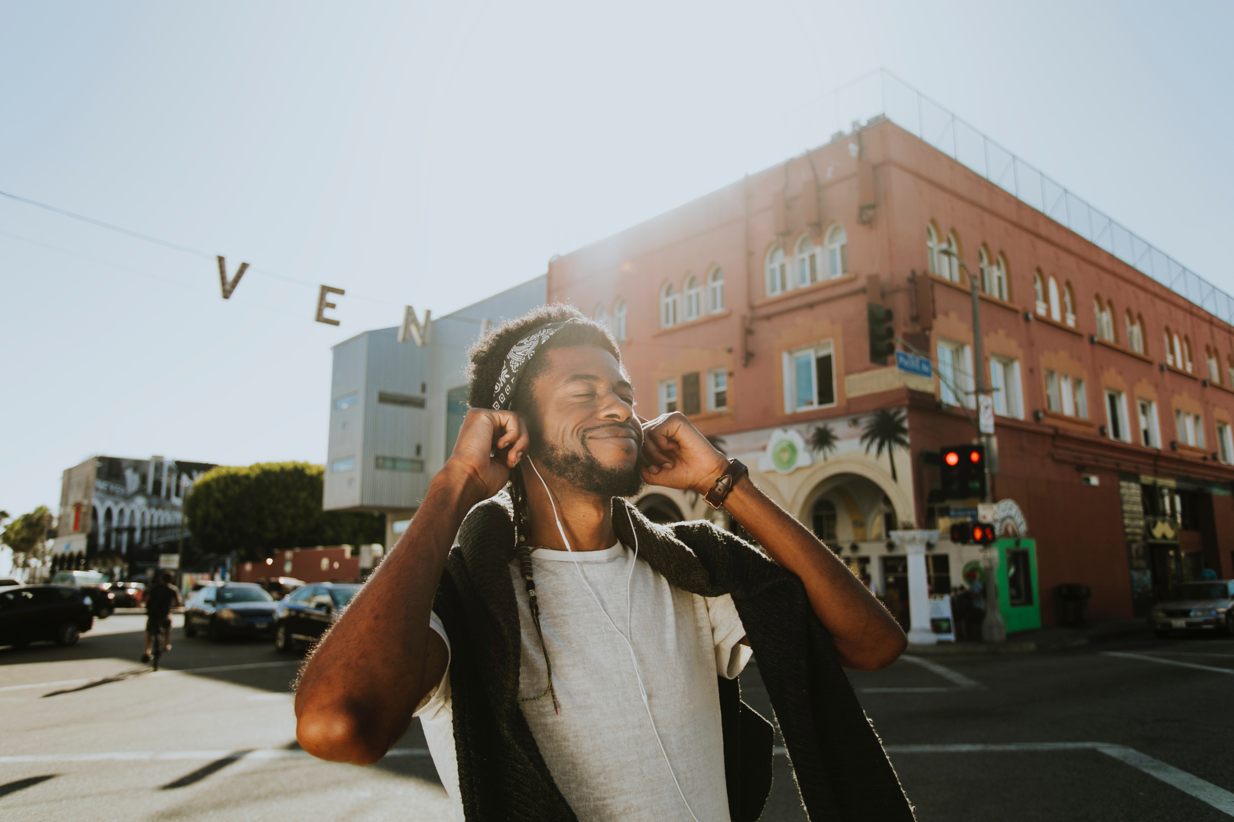 adult-architecture-bandana-1371177 Man Smiling While Listening to Music.
