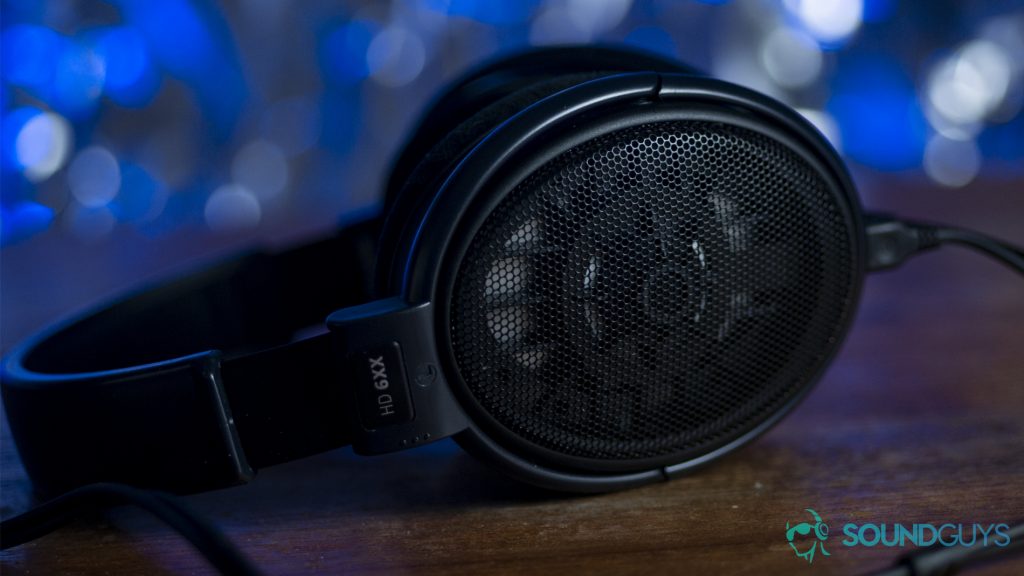 The Sennheiser HD 6XX headphones in black against a blurred out blue, shimmering background.