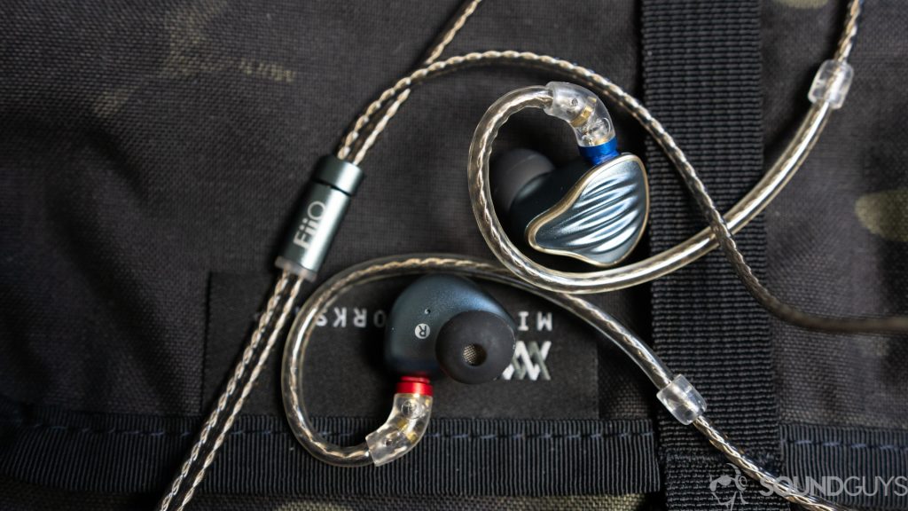 The Fiio FH5 in-ears housing design against a black bag.