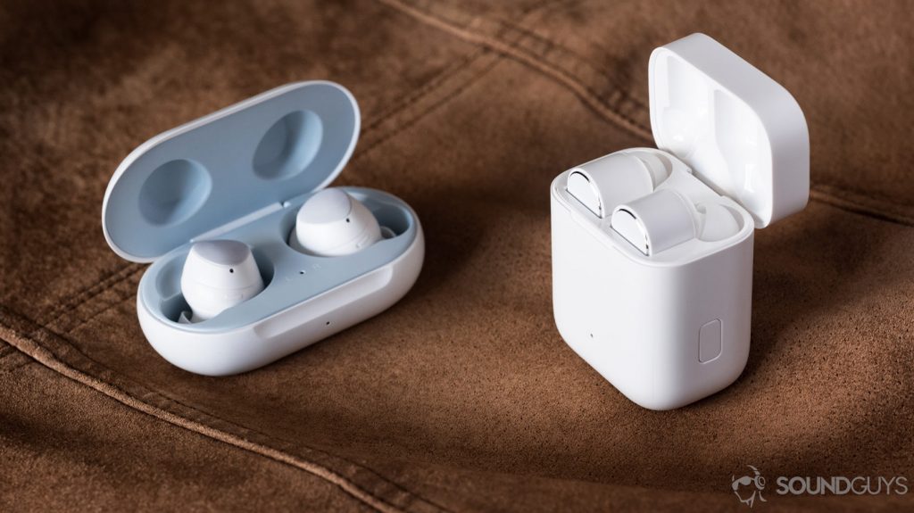Comparison of the Samsung Galaxy Buds and Xiaomi Mi True Wireless are in their respective cases, which are open.