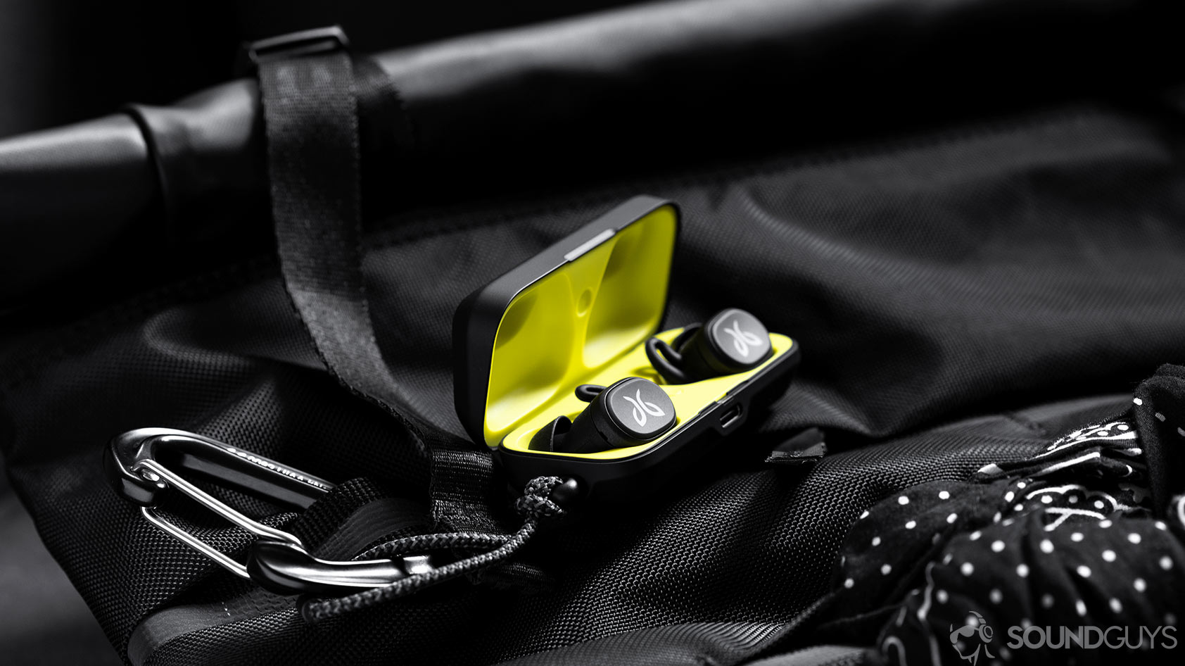 Jaybird Vista-1_earbuds charging case backpack The Jaybird Vista earbuds in charging case which is open and on a Chrome backpack.