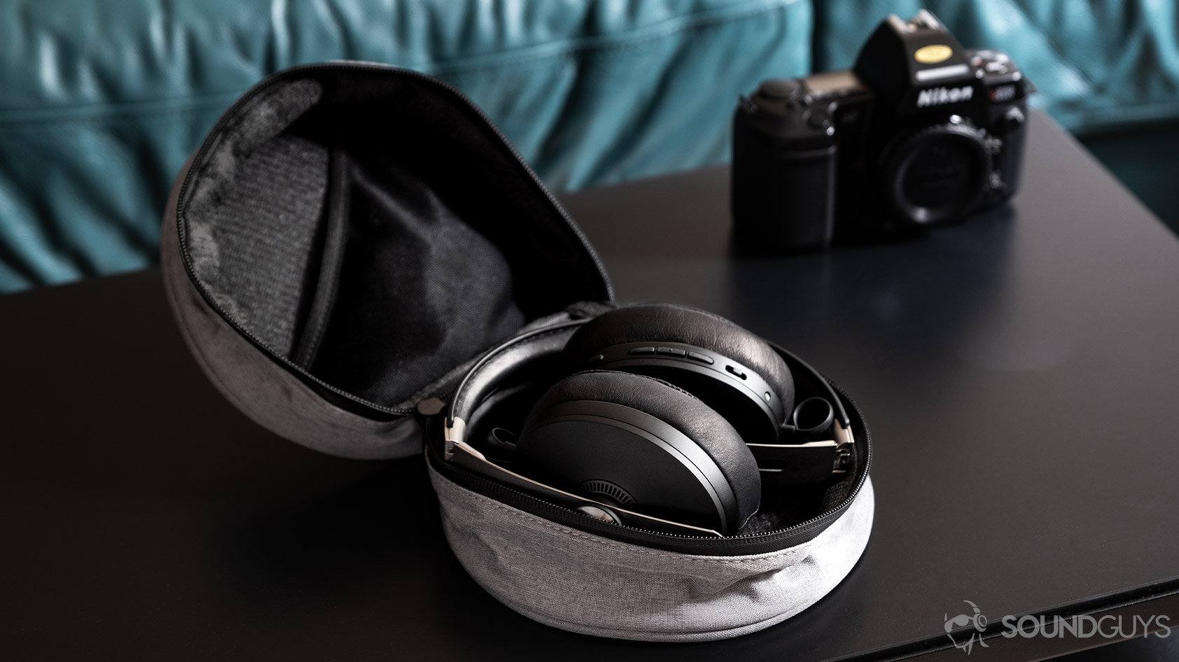 The Sennheiser Momentum Wireless 3 headphones folded in the grey carrying case.