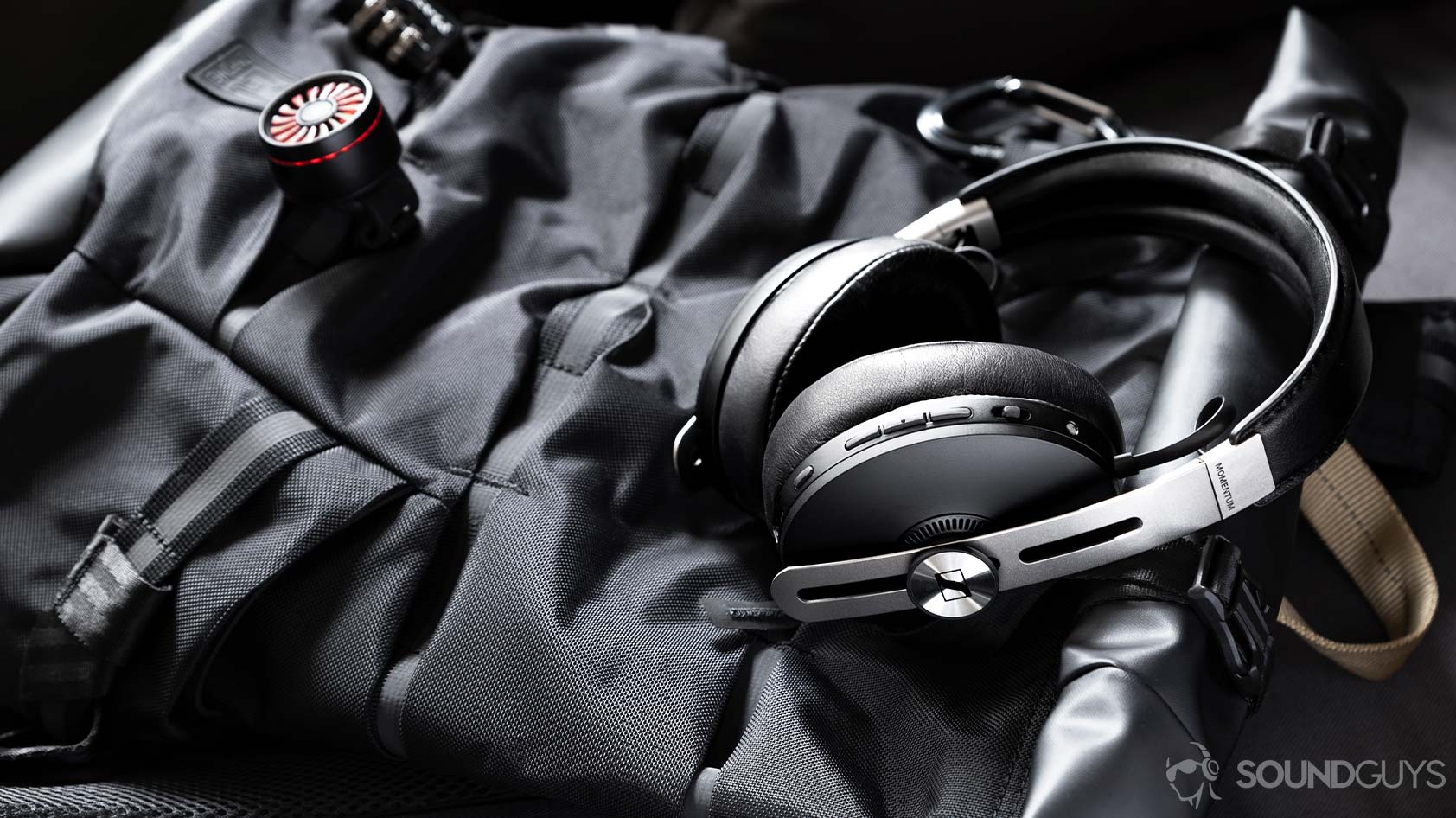 Sennheiser Momentum Wireless 3-3_headhones backpack A photo of the Sennheiser Momentum Wireless 3 headphones lying flat on a backpack.