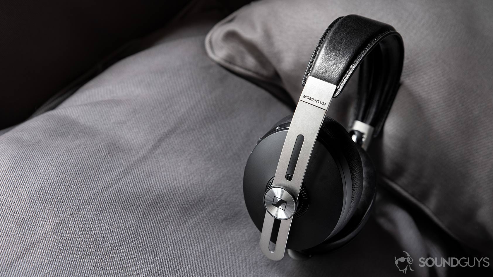 The Sennheiser Momentum Wireless 3 on a grey pillow.