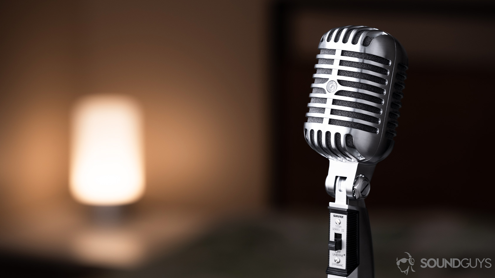 Image of the Shure 55SH angled away from the camera with a warm light in the background.