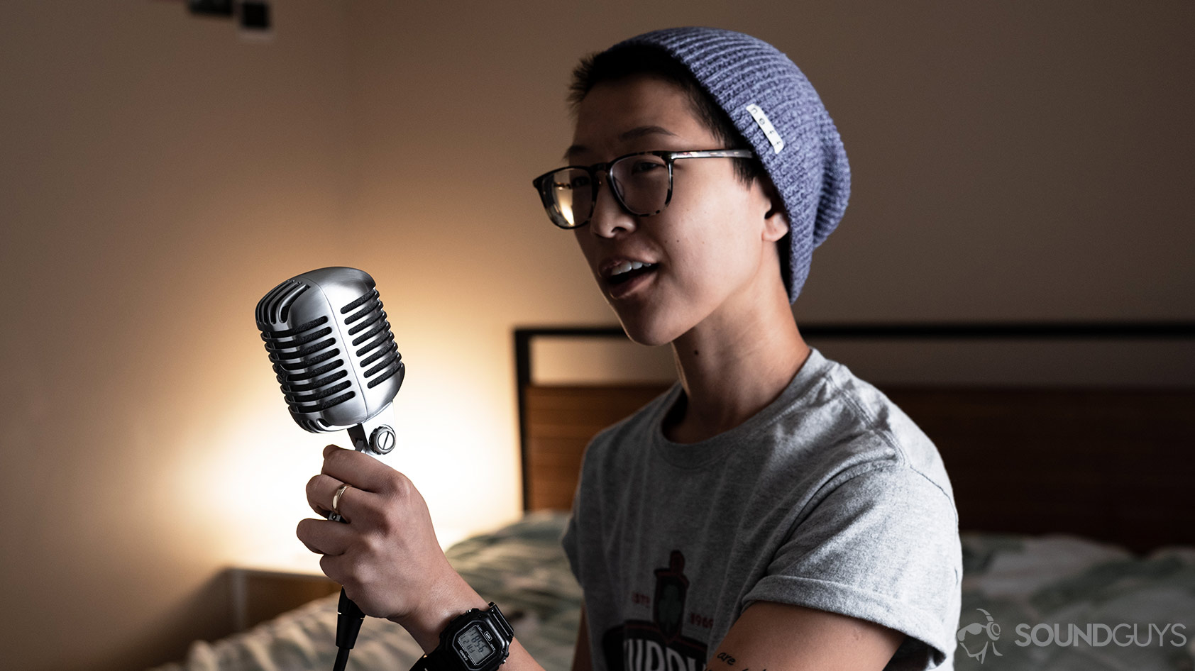 Shure 55SH dynamic cardioid microphone being held by a woman.