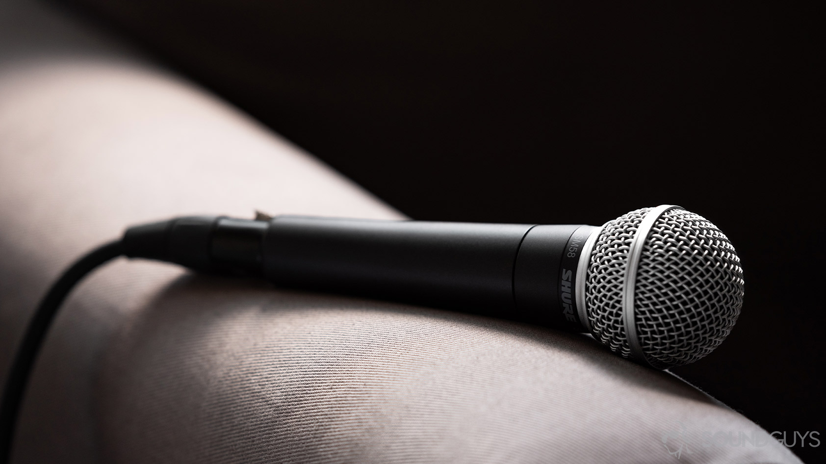 A photo of the Shure SM58 on the arm of a couch.